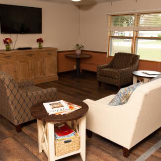 A cozy living room setup featuring comfortable seating and a television.