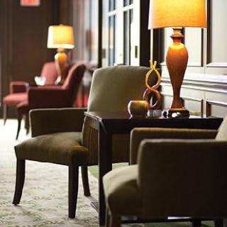 A cozy hotel lounge with comfortable chairs and warm lighting.