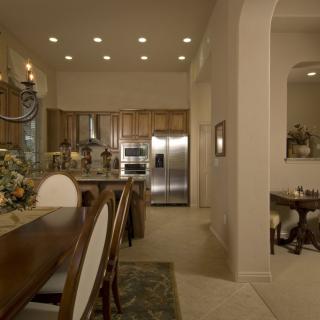 A modern kitchen and dining area with wooden furniture and stainless steel appliances.