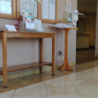 A cozy lobby area featuring wooden furniture and informational displays.