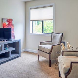 A cozy living room with comfortable seating and a television.