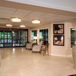 A spacious and elegantly designed lobby with comfortable seating, contemporary lighting, and artwork on the walls.