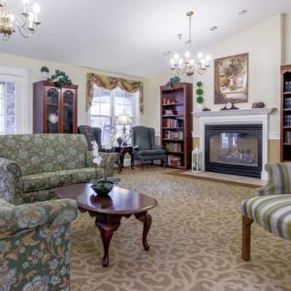 A cozy living room with elegant furniture and a fireplace.