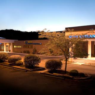 A view of a commercial building at dusk, illuminated by exterior lights.
