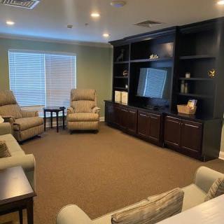 A cozy living room with comfortable seating, a large television, and a warm ambiance.