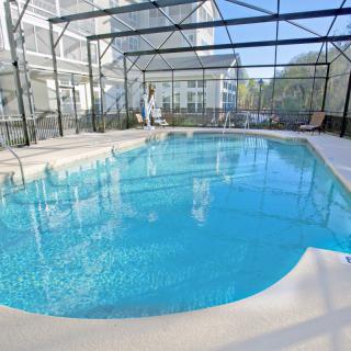 An indoor swimming pool enclosed in a spacious residential setting.