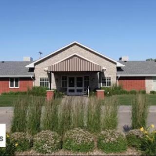 A welcoming exterior view of a building set against a clear blue sky.