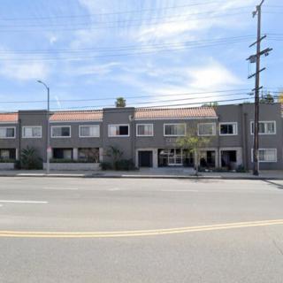 A row of residential buildings along an urban street.