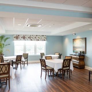 A bright and elegantly decorated dining room with neatly arranged tables and chairs.
