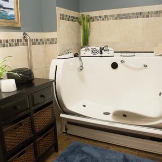 A modern bathroom featuring a walk-in bathtub and stylish interior design.