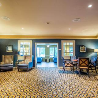 A spacious lobby area featuring comfortable seating and elegant decor.