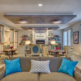 A beautifully designed modern living room with stylish furniture and vibrant accents.