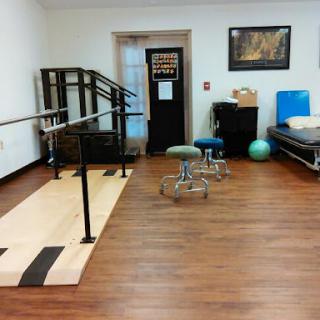 A view of a therapy room equipped for rehabilitation exercises.