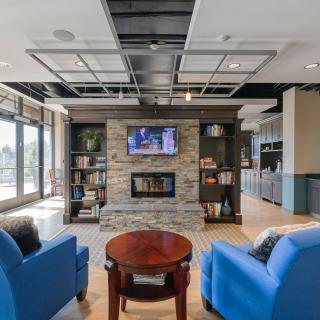A modern living room featuring a fireplace, television, and comfortable seating.