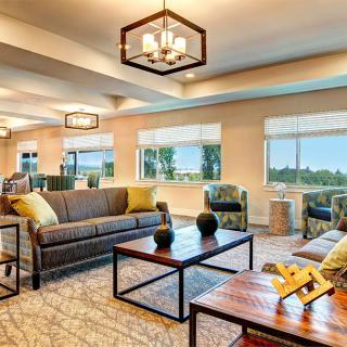 A modern living room with stylish furniture and large windows offering a bright atmosphere.