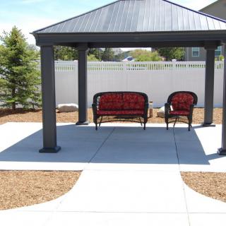 A patio with a gazebo and outdoor seating.