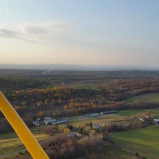 A breathtaking aerial view of a serene countryside landscape during sunset.