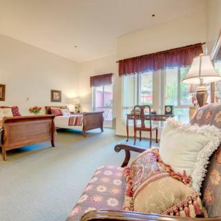 A cozy living room with elegant furniture and large windows letting in natural light.