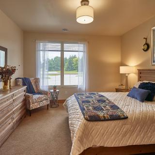 A cozy bedroom with warm lighting and stylish decor.