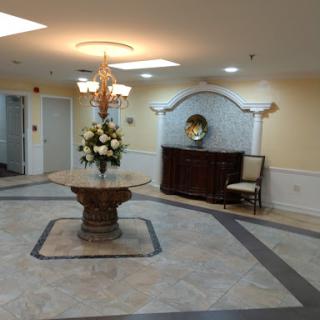 A beautifully decorated lobby featuring a floral centerpiece and elegant furnishings.
