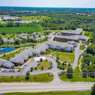 A peaceful aerial view of a well-maintained residential complex surrounded by lush greenery.