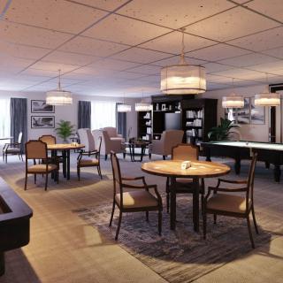 A spacious and modern living area with elegant dining tables, comfortable seating, and stylish lighting fixtures.