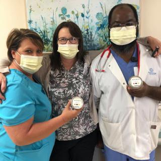 Healthcare professionals proudly showing their commitment to patient care.