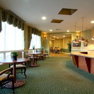 A spacious lobby with elegant furniture and subdued lighting.