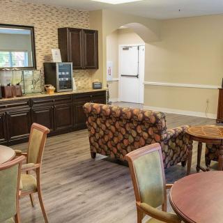 A cozy lounge area with chairs, tables, and a sofa arranged for comfort.