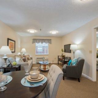 A cozy living and dining area with elegant table settings and warm lighting.