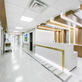A modern and clean hospital reception area with elegant lighting design.