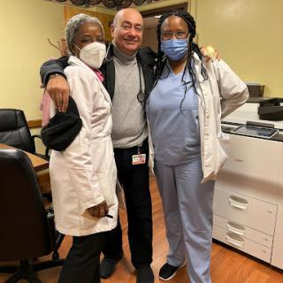 A joyful moment among healthcare professionals in a medical setting.