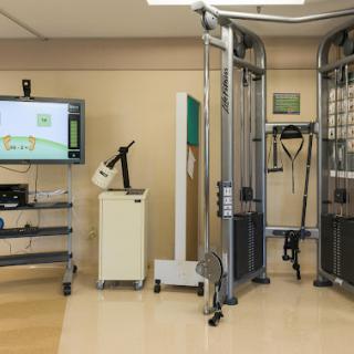 A well-equipped physical therapy room featuring various rehabilitation machines and monitoring systems.