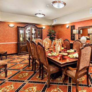 A luxurious dining room with an ornate table set and elegant decor.