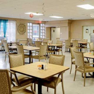 A spacious and inviting dining area with neatly arranged tables and chairs, ready for patrons.