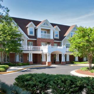 A beautiful residential building with classic architecture and well-maintained landscaping.