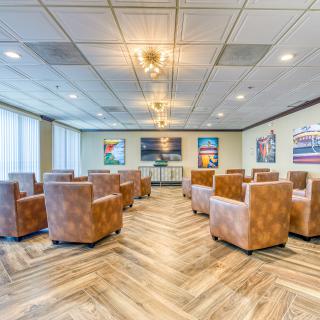 A spacious and modern conference room with comfortable seating and art-adorned walls.