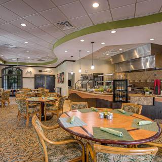A modern and inviting dining area with neatly arranged tables and chairs, featuring contemporary decor.