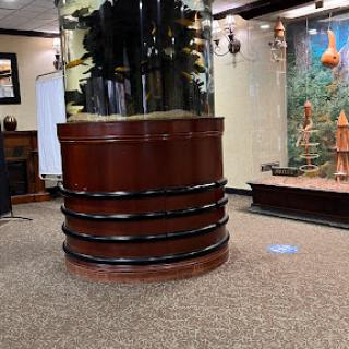 A stylish round aquarium integrated into an elegant interior space.