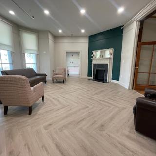 A modern living room featuring an inviting layout with stylish furniture and beautiful laminate flooring.