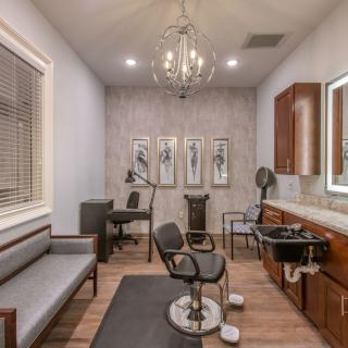 A modern hair salon interior with stylish decor and elegant lighting.