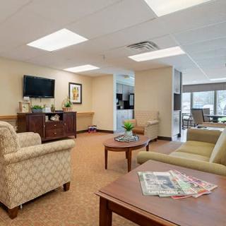 A cozy and well-lit communal lounge area with comfortable seating and modern decor.