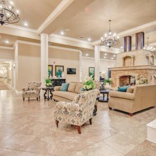 A spacious and elegantly decorated hotel lobby with comfortable seating and chandeliers.