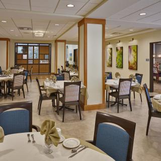 A well-organized restaurant dining area with neatly set tables and chairs, showcasing elegant interior design.