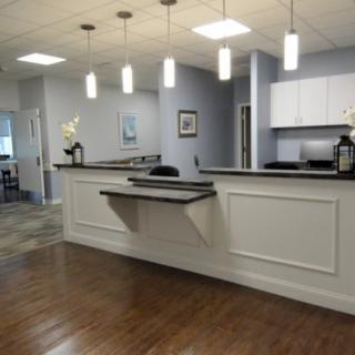 A modern office reception area with a clean and minimalist design.