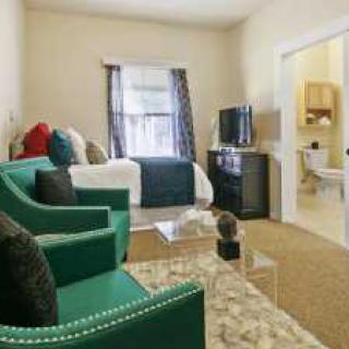A cozy modern living room with a sofa, TV, and stylish decor.