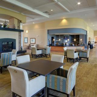 A modern dining area with elegant furniture and soft lighting.