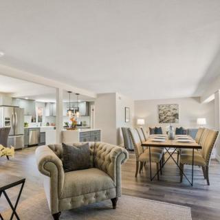 A spacious, modern open-plan living and dining area with elegant furnishings and a cozy ambiance.