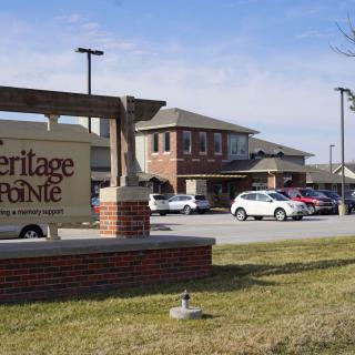 A nursing home with a parking lot and visible signage.