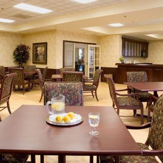 A spacious and neatly arranged dining area with tables set and a comfortable ambiance.